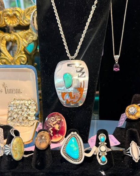 Sterling and turquoise rings and pendants in a jewelry showcase