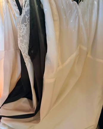 Vintage lace-trimmed slips hanging on a rack